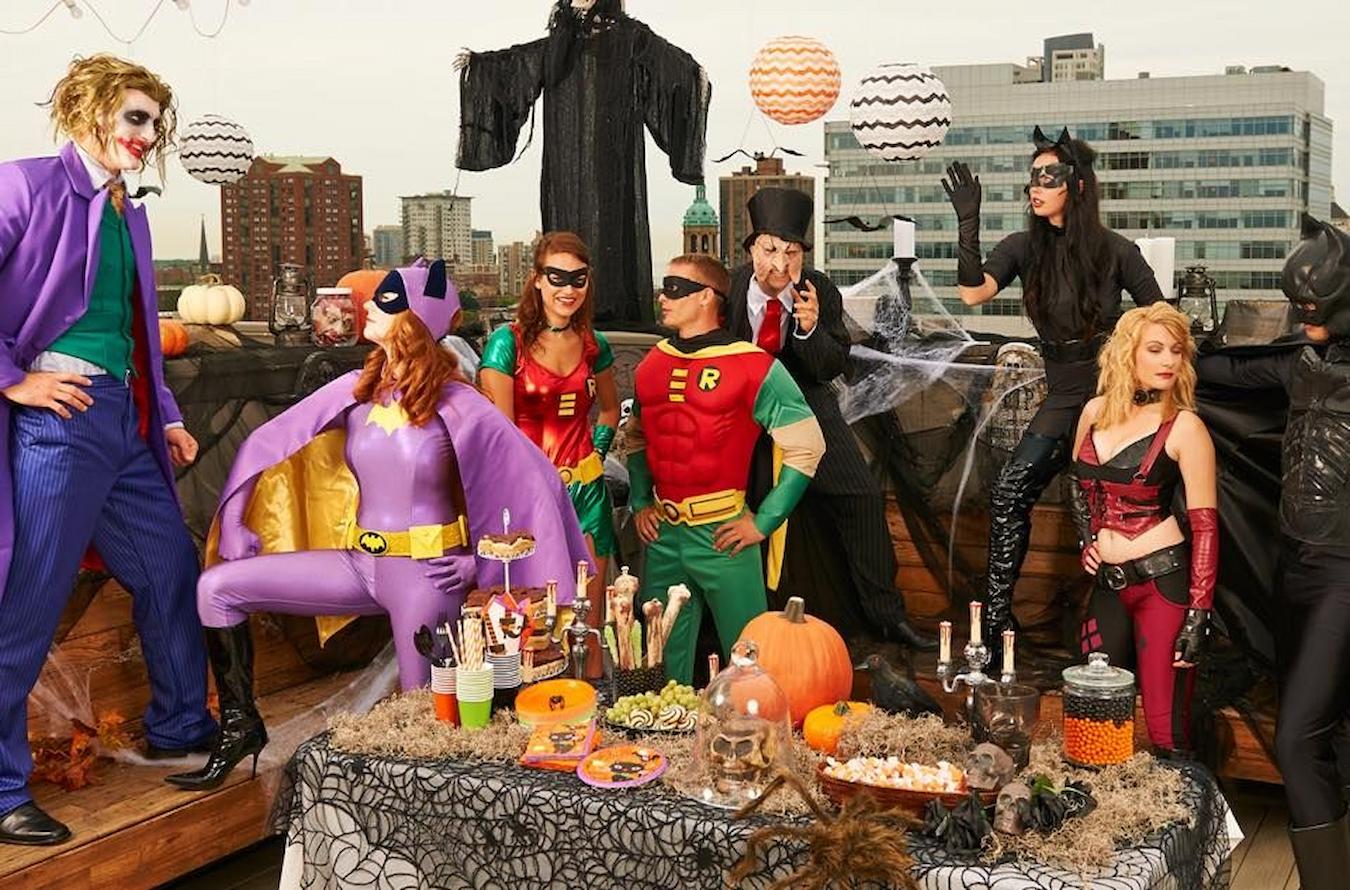 a group of people dressed up as different superheroes winter wonderland office Olympics line dancing james bond food options james bond