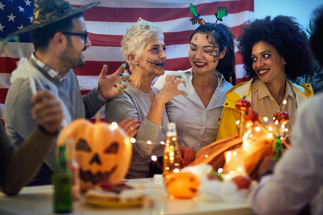 a group of people in Halloween costumes talking at a party monster mash fun time little fun spider cupcakes co workers in person costumes