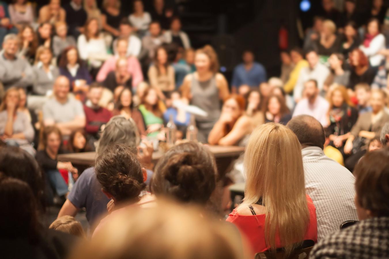 Attendees listen to speaker with great audience control give tips on career preparation