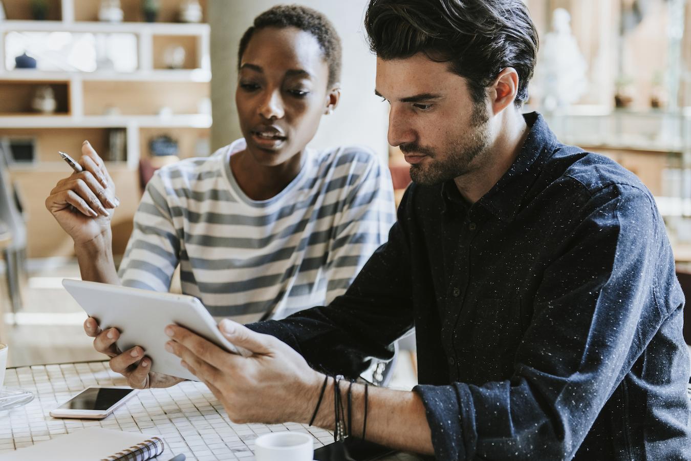 Colleagues look at tablet