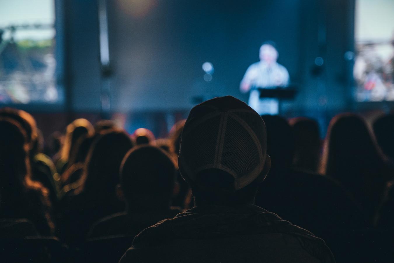 crowd watching someone speaking on a stage ability talk deliver confidence credibility conference keynote speaker sets key points lasting impression audience