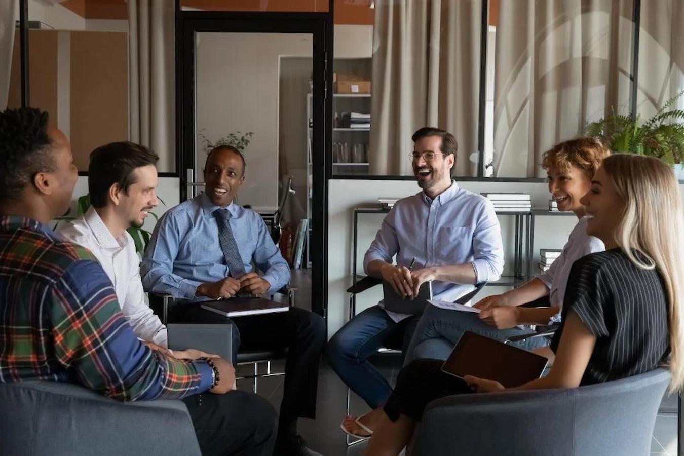 group of employees sitting together talking and laughing team building activity office gift ideas office gifts fun game a few ideas healthy snacks fun way trivia games office activities extended period team activities happy hour event planning event planning