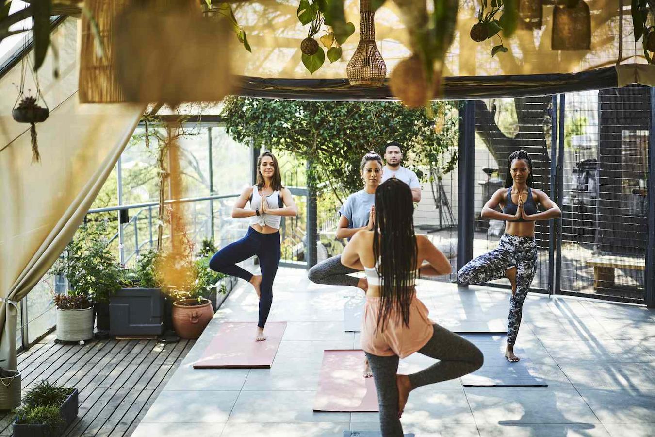 group of people doing yoga outside remote teams retreat planning board games few hours company retreat ideas retreat venue company retreats