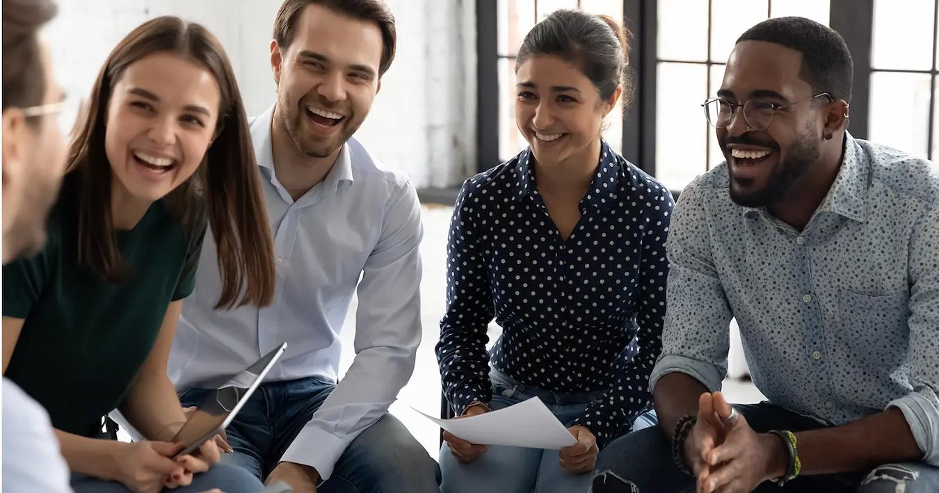 group of people laughing at work mini golf tournament co workers scavenger hunt event planning happy hour new employees scavenger hunt event planning remote workers event planning office game well being local gym