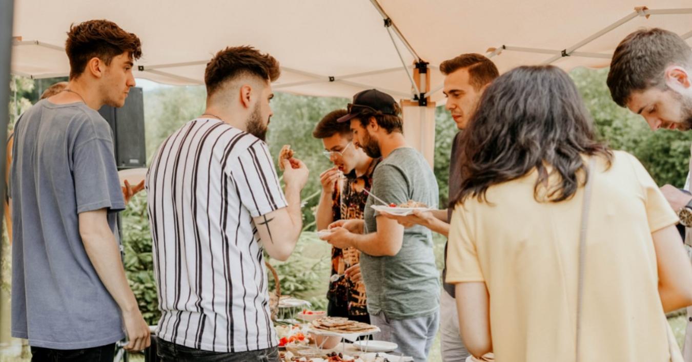 group of people socializing and eating from outdoor event buffet benefits of events business event attending events thought leadership potential customers in person example sales brand attending community