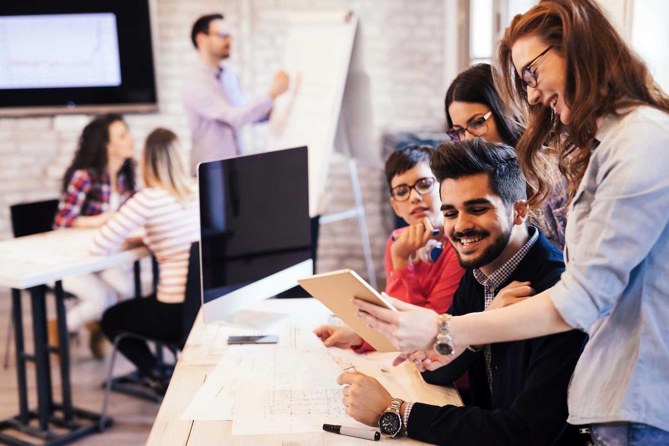 group of workers looking at a document together break forget sun future focus vacation manage boost matter break