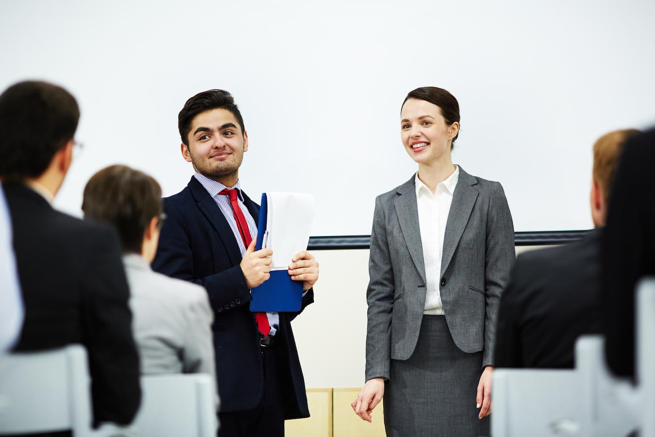 Man in conference room is proud to introduce speaker to talk to staff about ideas for success
