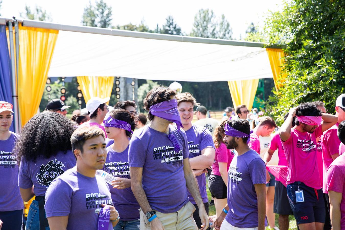 people wearing purple at an outdoor sports day hot day outdoor space team member company summer event fresh air