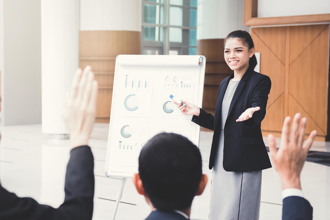 Person from lineup of speakers impresses with confident speaking abilities and detailed chart