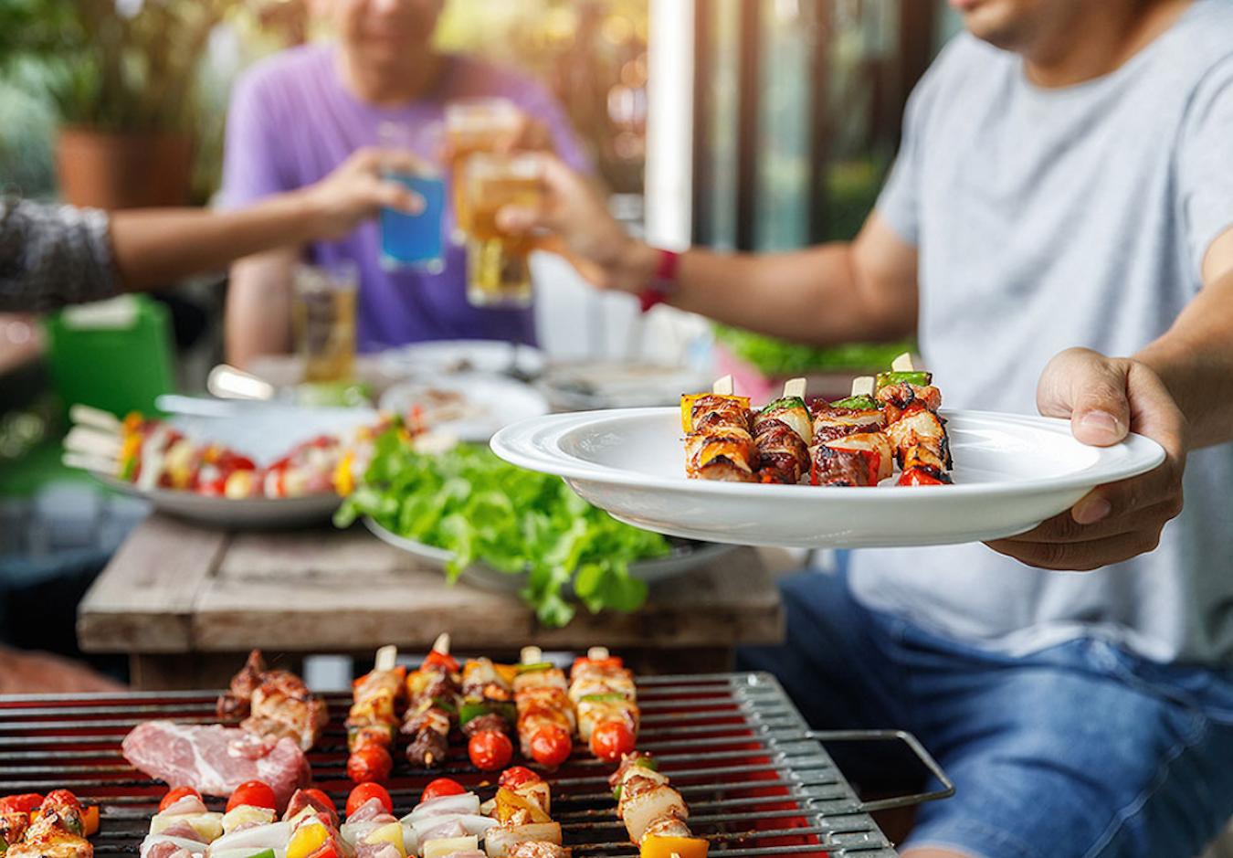 someone grilling a kebab for a bbq creative corporate event themes classic fair food serve food carnival theme ideas corporate party theme ideas